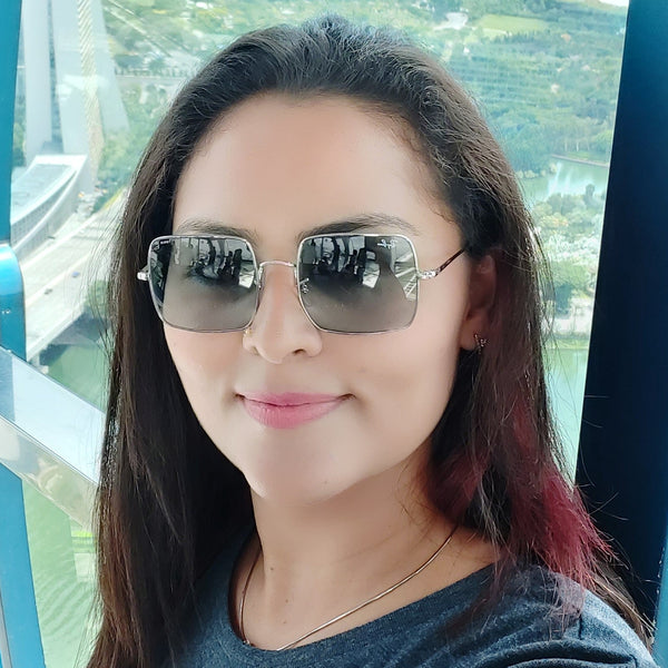 Woman wearing sunglasses with a scenic background